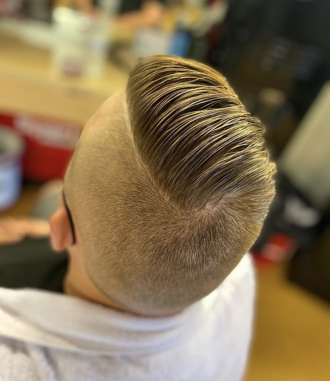 Blonde pompadour with bald fade by Kay