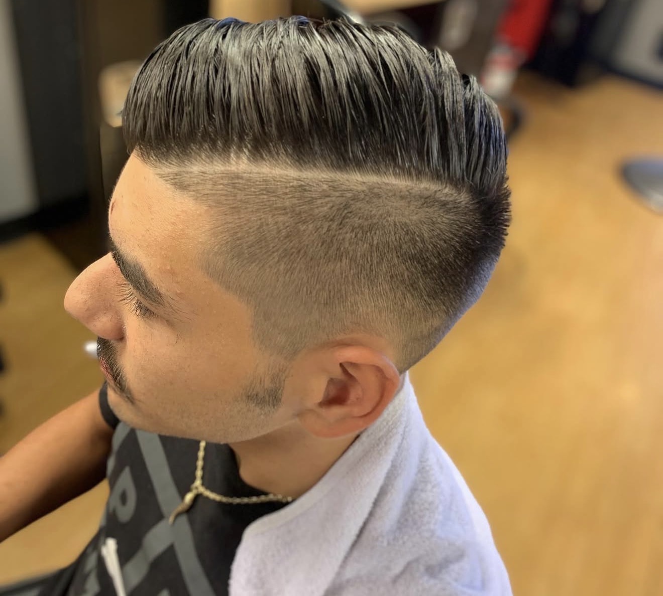 Slick comb-over with mid fade by Kay