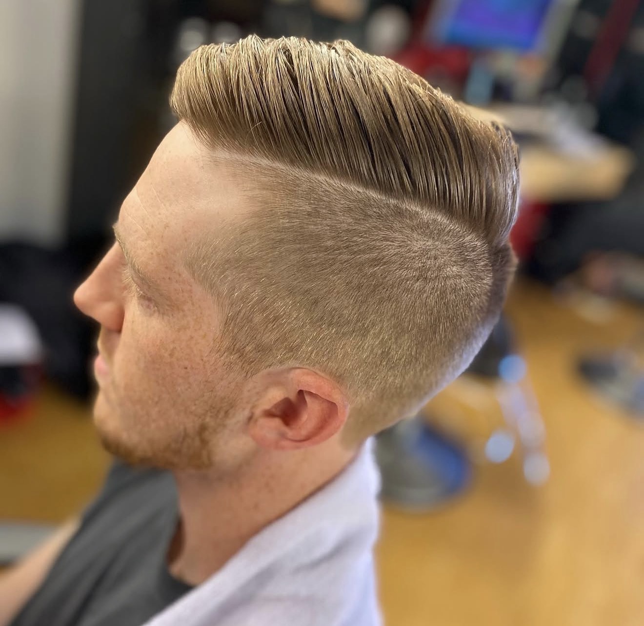 Slicked-back pomp with razor fade by Kay